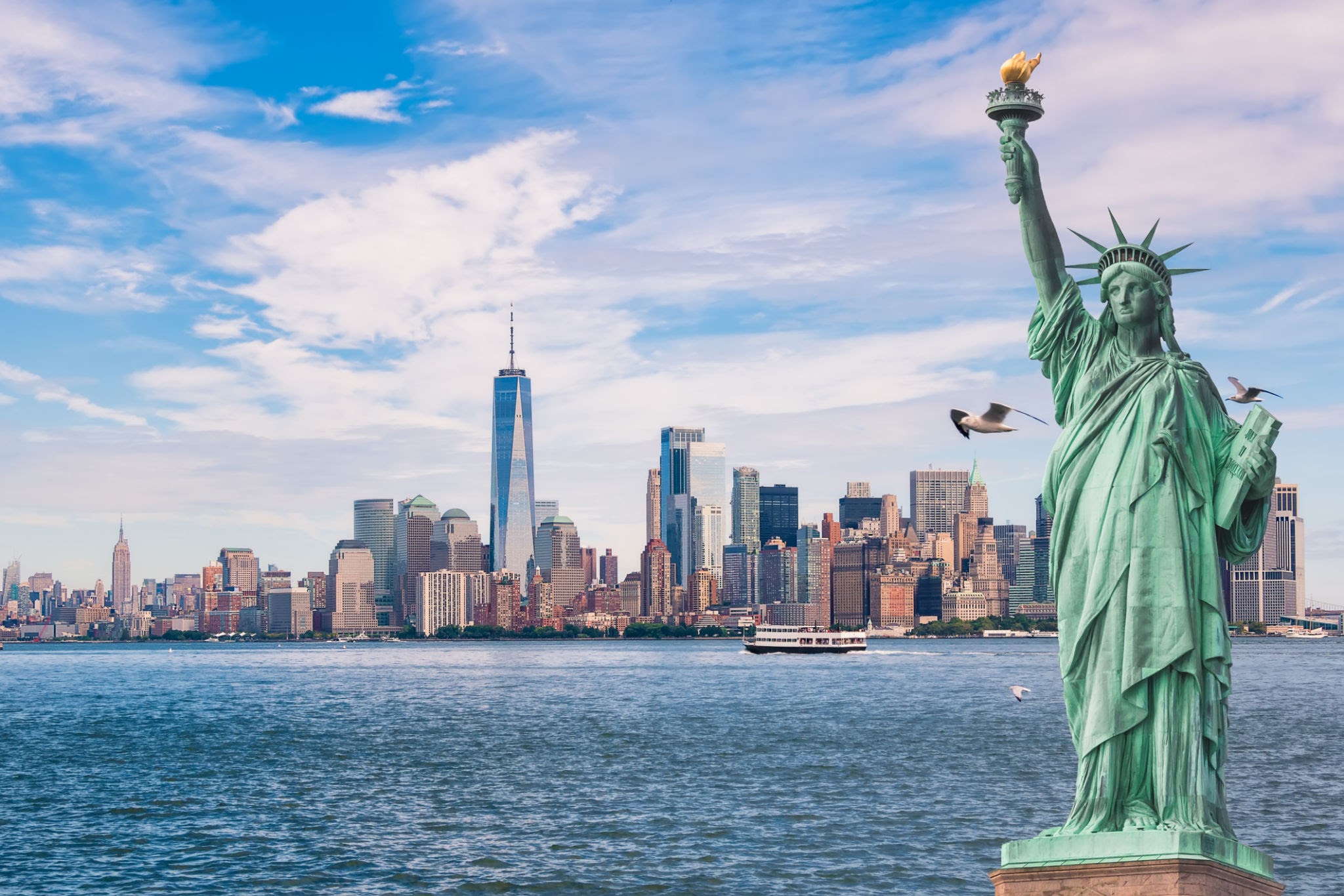 statue of liberty in front of the manhattan skyline, with seagulls and boats